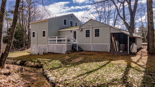 rear view of property with a wooden deck