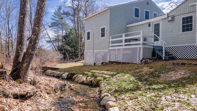 rear view of house featuring a deck and stairs