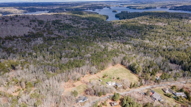 aerial view with a water view and a forest view