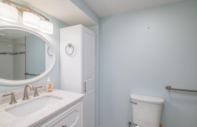 bathroom with toilet and vanity