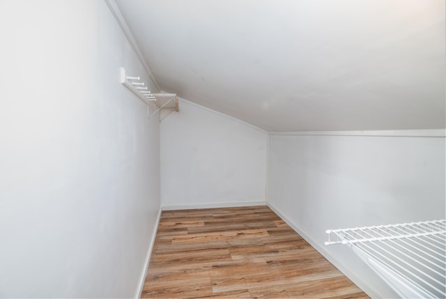 spacious closet with vaulted ceiling and light wood-style floors