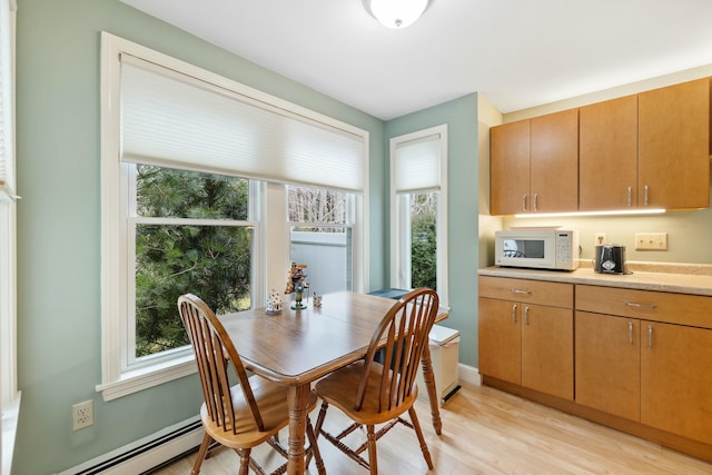 12 Ephraim Tyler Way Unit 12, Kennebunk, ME 04043 - dining space featuring a baseboard radiator, healthy amount of natural light, and light wood finished floors