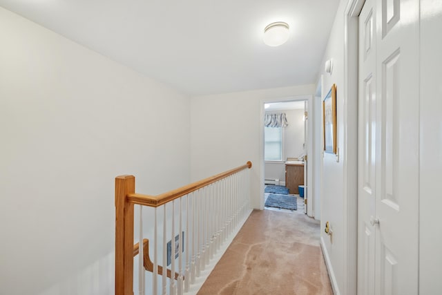 12 Ephraim Tyler Way Unit 12, Kennebunk, ME 04043 - hall featuring an upstairs landing, light colored carpet, and a baseboard radiator