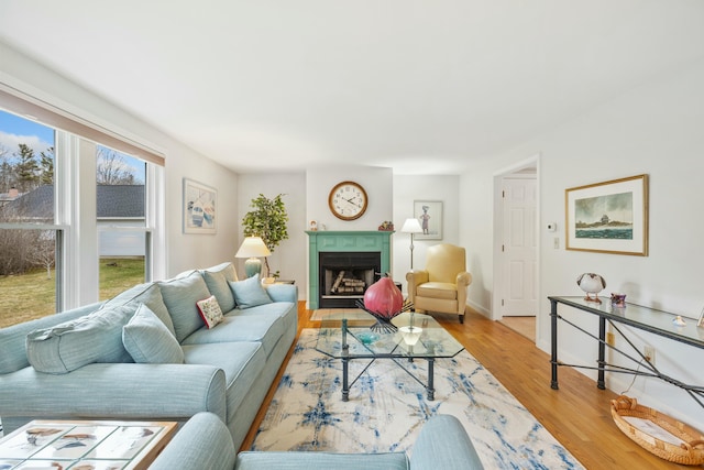 12 Ephraim Tyler Way Unit 12, Kennebunk, ME 04043 - living area featuring light wood-style flooring, a fireplace with flush hearth, and baseboards