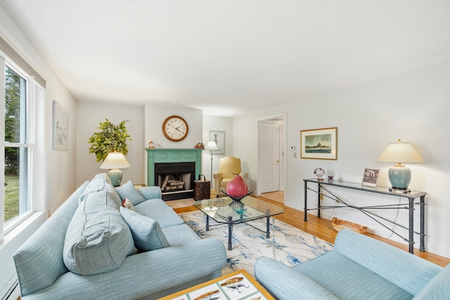12 Ephraim Tyler Way Unit 12, Kennebunk, ME 04043 - living area with wood finished floors, a fireplace with flush hearth, and baseboards