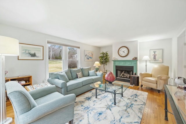 12 Ephraim Tyler Way Unit 12, Kennebunk, ME 04043 - living area with light wood-style floors and a fireplace with flush hearth