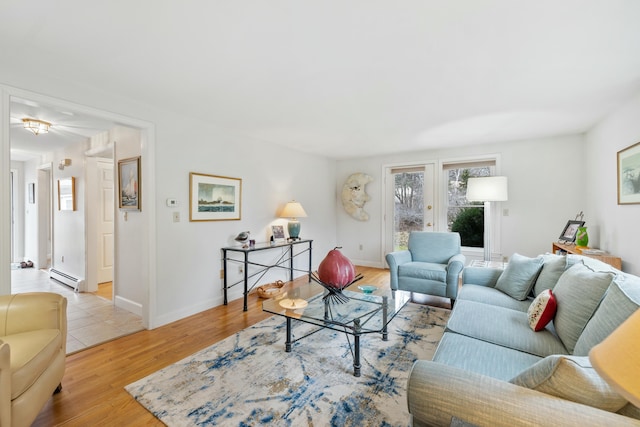 12 Ephraim Tyler Way Unit 12, Kennebunk, ME 04043 - living area with baseboard heating, wood finished floors, french doors, and baseboards