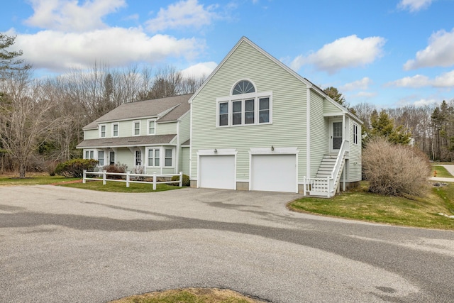 12 Ephraim Tyler Way Unit 12, Kennebunk, ME 04043 - view of front facade featuring asphalt driveway, an attached garage, and stairway