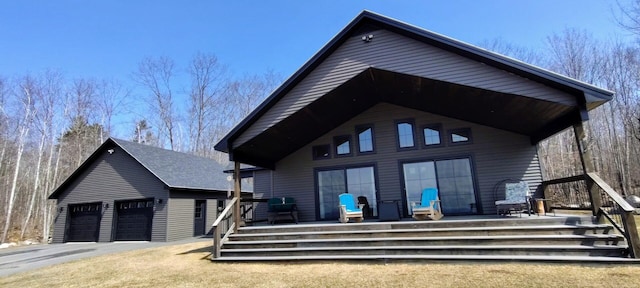 exterior space with a garage and an outbuilding