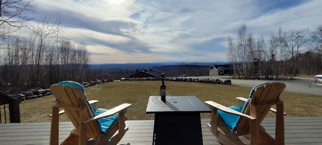 dock area with a lawn and a deck with mountain view