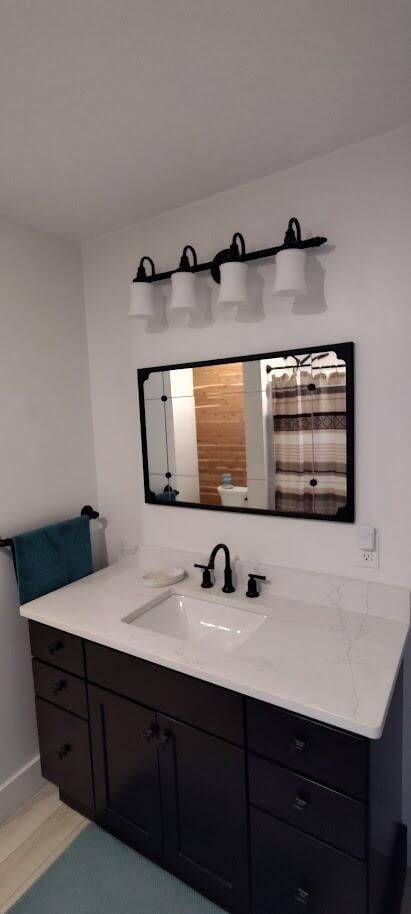 bathroom featuring baseboards and vanity