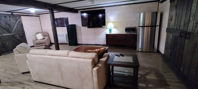 living area with wood finished floors and wood walls