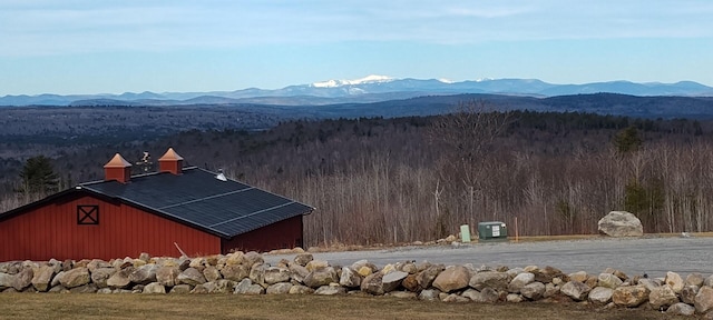 property view of mountains featuring a wooded view