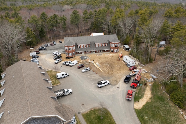 drone / aerial view with a wooded view