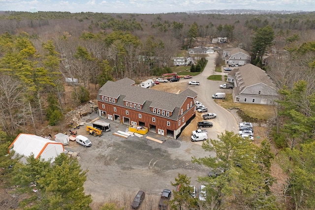 bird's eye view with a wooded view