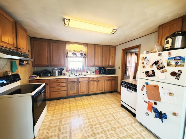 9 Locust St, Madison, ME 04950 - kitchen featuring under cabinet range hood, white appliances, a sink, and brown cabinets