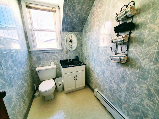 9 Locust St, Madison, ME 04950 - bathroom with a baseboard radiator, tile walls, toilet, and vanity