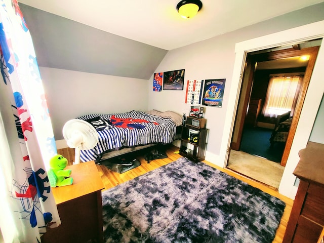 9 Locust St, Madison, ME 04950 - bedroom with vaulted ceiling, baseboards, and wood finished floors