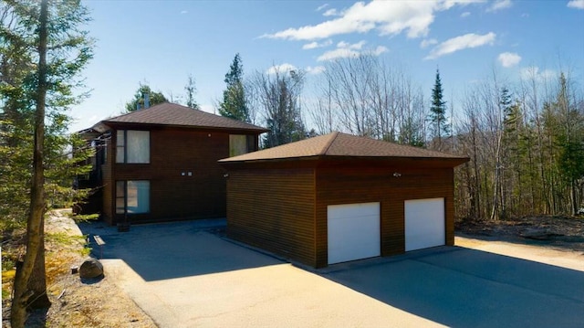 exterior space with an outbuilding and a garage