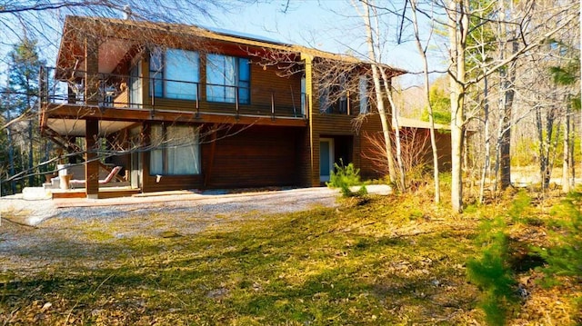 back of property with a balcony