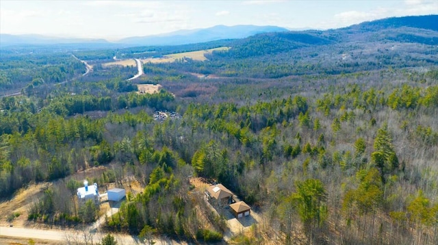 bird's eye view featuring a wooded view and a mountain view