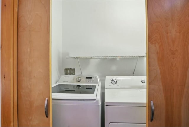laundry area with washer and clothes dryer and laundry area