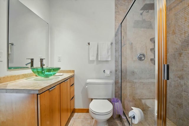 full bathroom featuring tile patterned flooring, vanity, toilet, and a stall shower