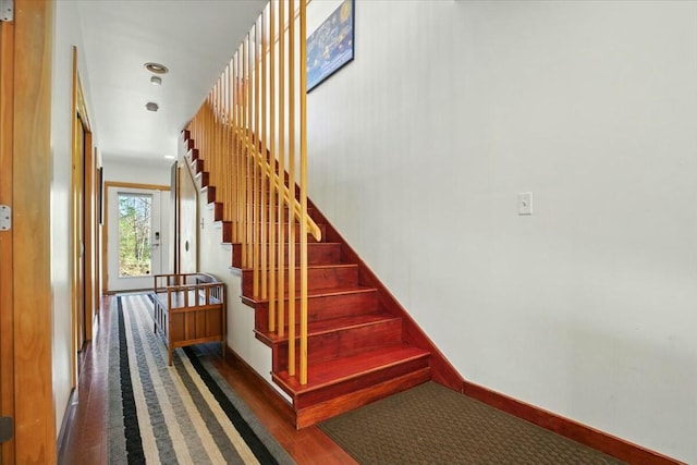 stairs featuring baseboards and wood finished floors