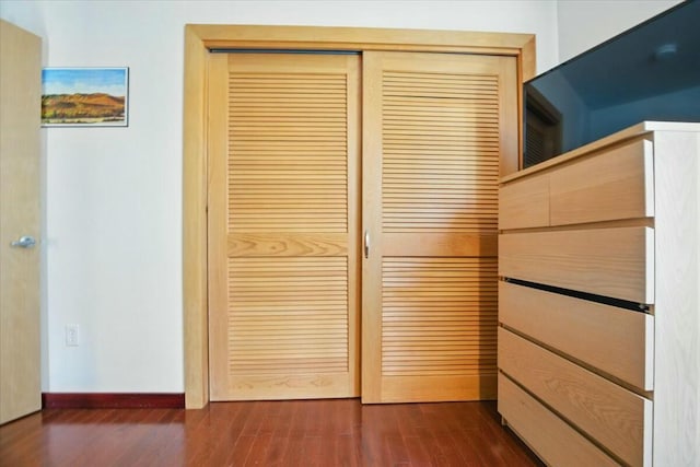 interior details featuring baseboards and wood finished floors