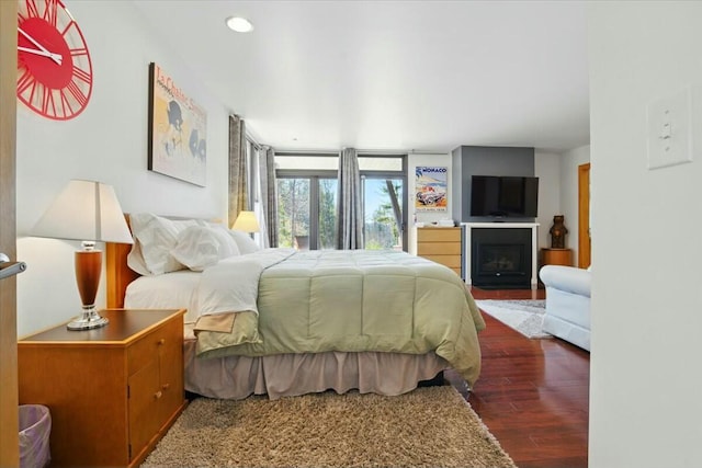 bedroom with wood finished floors and recessed lighting