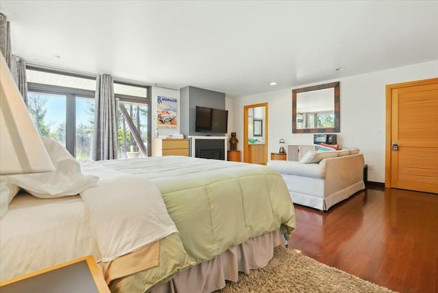 bedroom with recessed lighting, hardwood / wood-style floors, and multiple windows