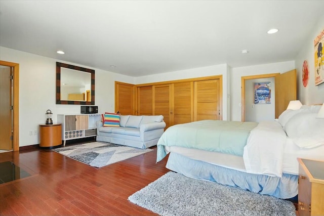bedroom with a closet, wood finished floors, and recessed lighting