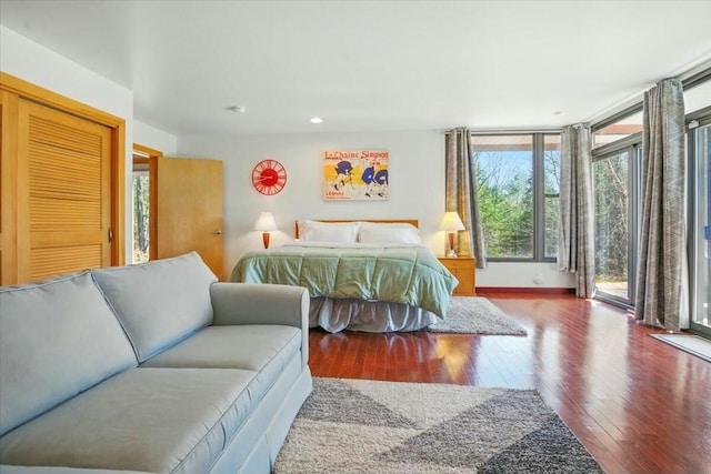 bedroom featuring recessed lighting, access to exterior, and hardwood / wood-style flooring
