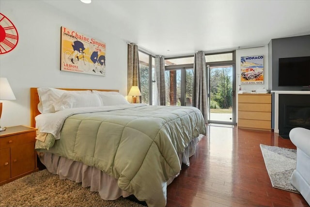 bedroom with wood finished floors and access to exterior