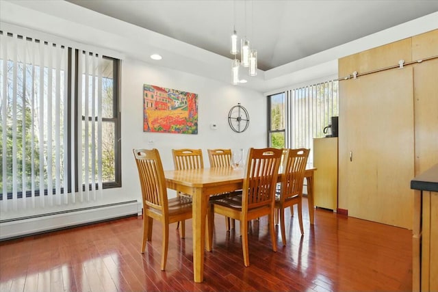 dining area with a baseboard heating unit, wood-type flooring, a chandelier, and recessed lighting