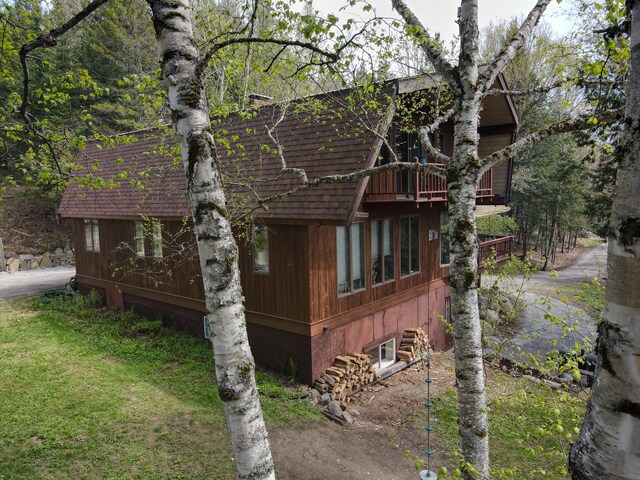 823 Grindstone Rd, Medway, ME 04460 - view of side of property with a balcony and a yard