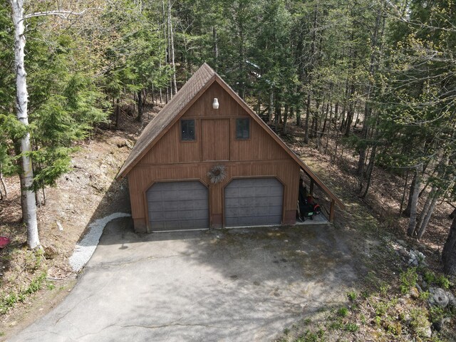 823 Grindstone Rd, Medway, ME 04460 - garage featuring a garage and a forest view