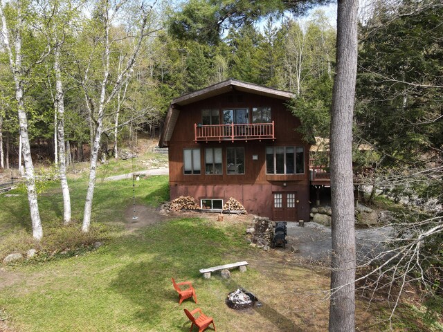 823 Grindstone Rd, Medway, ME 04460 - view of front of home with a front yard and a balcony