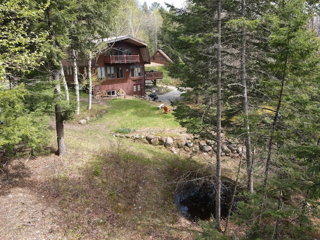 823 Grindstone Rd, Medway, ME 04460 - view of green lawn featuring a forest view and a deck