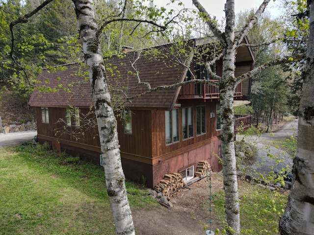 823 Grindstone Rd, Medway, ME 04460 - view of side of property with a balcony and a yard