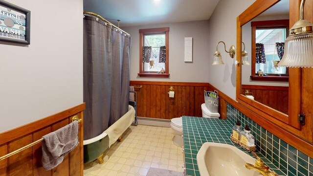823 Grindstone Rd, Medway, ME 04460 - full bathroom featuring a wainscoted wall, baseboard heating, toilet, a shower with shower curtain, and tile patterned floors