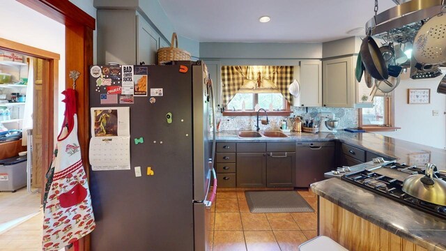 823 Grindstone Rd, Medway, ME 04460 - kitchen with freestanding refrigerator, a sink, dishwashing machine, dark countertops, and tasteful backsplash