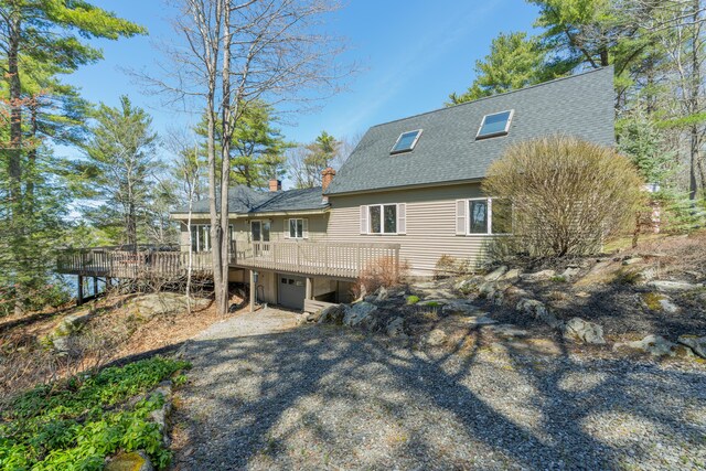 126 Middle Rd, Woolwich, ME 04579 - rear view of house with a chimney, roof with shingles, and a deck