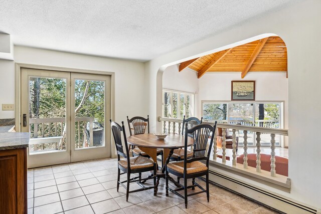 126 Middle Rd, Woolwich, ME 04579 - dining room with vaulted ceiling with beams, plenty of natural light, a baseboard heating unit, and arched walkways