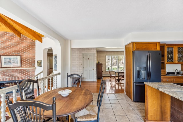 126 Middle Rd, Woolwich, ME 04579 - dining room with lofted ceiling with beams, arched walkways, and light tile patterned floors
