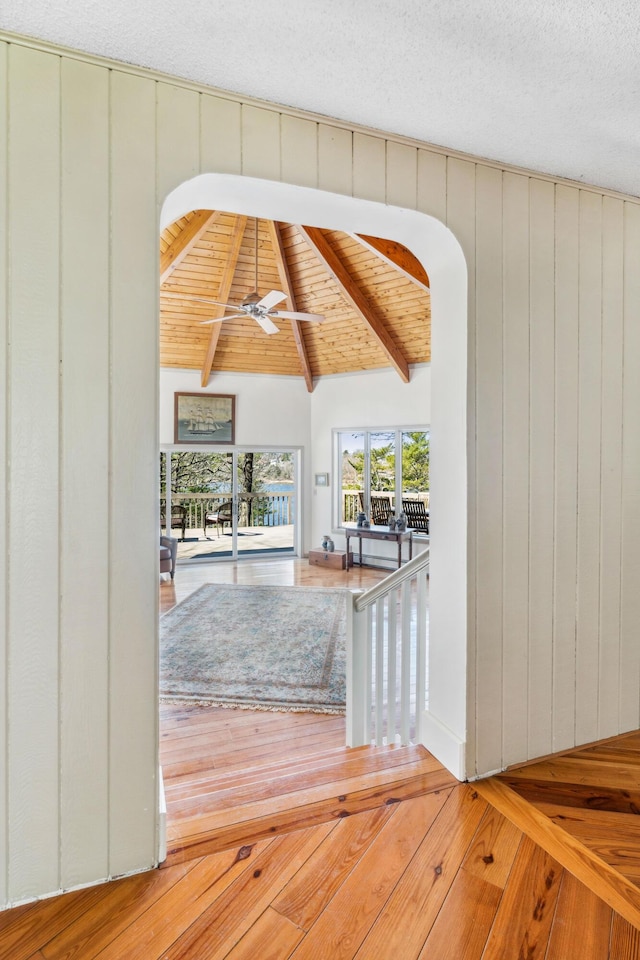 126 Middle Rd, Woolwich, ME 04579 - interior space with vaulted ceiling with beams, arched walkways, a ceiling fan, and wood finished floors