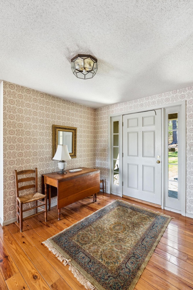 126 Middle Rd, Woolwich, ME 04579 - foyer featuring baseboards, a textured ceiling, hardwood / wood-style flooring, and wallpapered walls