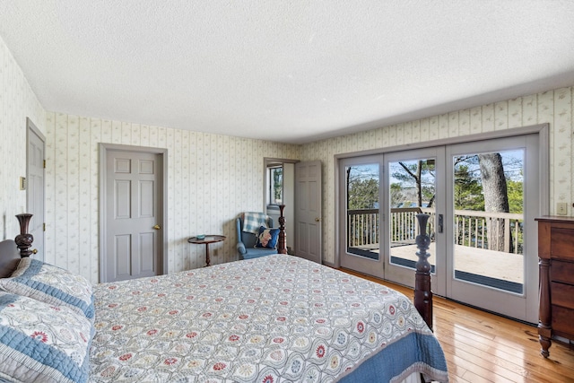 126 Middle Rd, Woolwich, ME 04579 - bedroom with a textured ceiling, access to exterior, french doors, hardwood / wood-style floors, and wallpapered walls