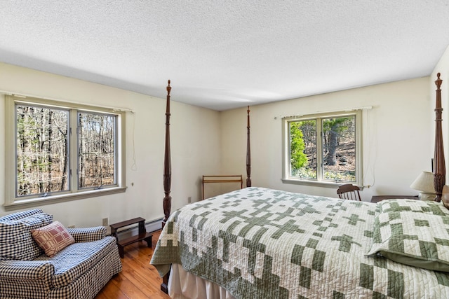 126 Middle Rd, Woolwich, ME 04579 - bedroom with a textured ceiling, wood finished floors, and a baseboard radiator