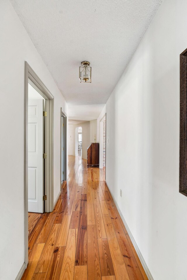 126 Middle Rd, Woolwich, ME 04579 - corridor featuring baseboards, a textured ceiling, and light wood-style flooring